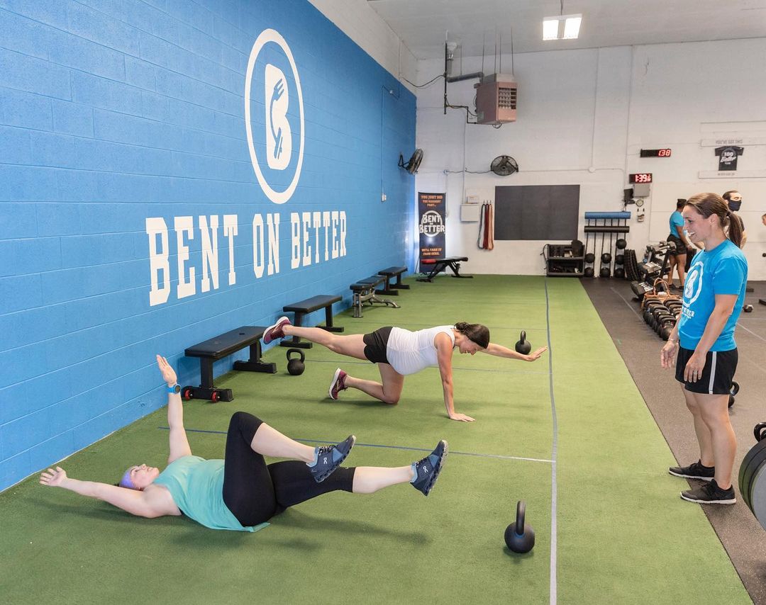 two women in a pre/postnatal fitness class doing core work